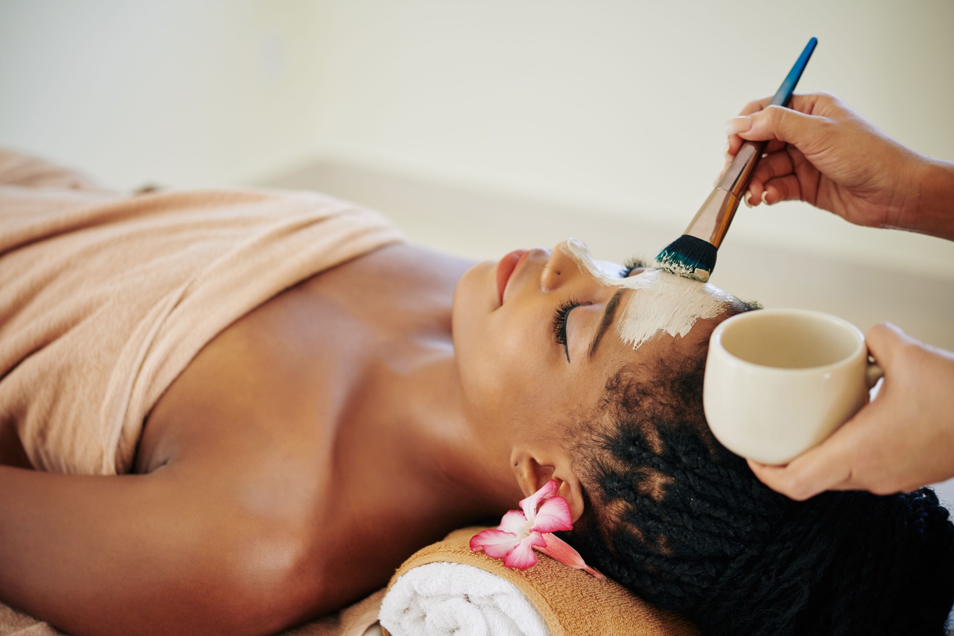 Beautician applying clay mask